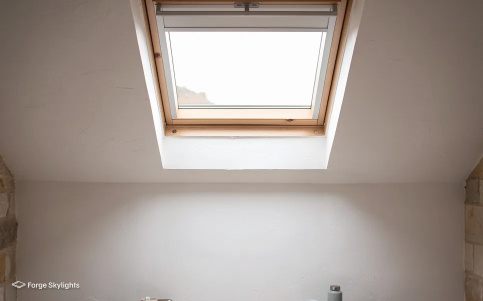 A bright room with a pine roof window in the ceiling