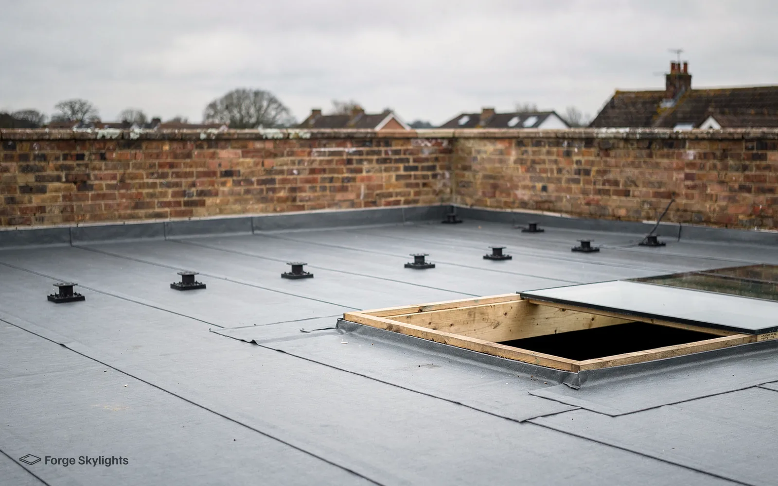A timber kerb prepared on a flat roof ready for walk-on glass