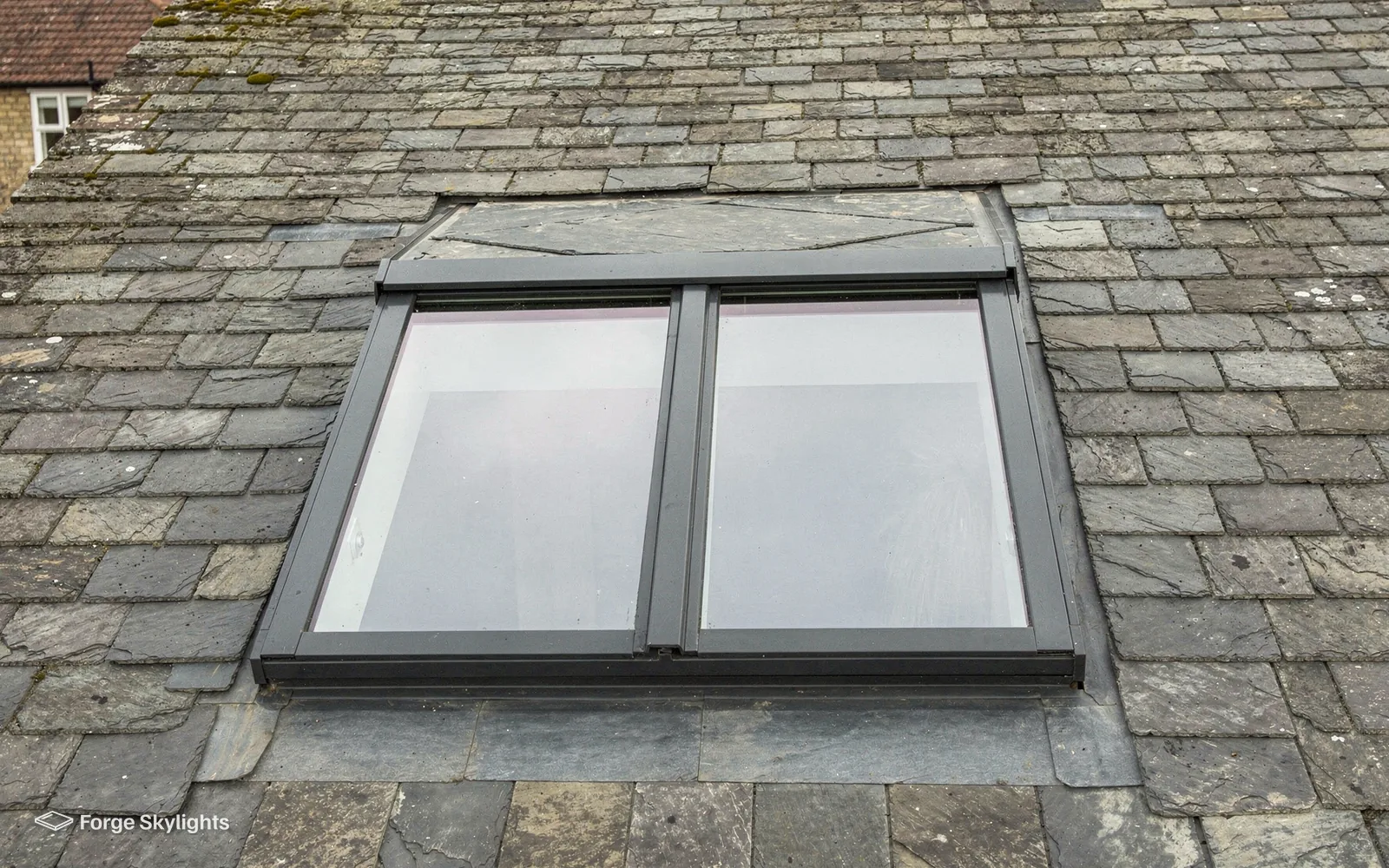 A conservation rooflight with a central glazing bar in an old slate roof