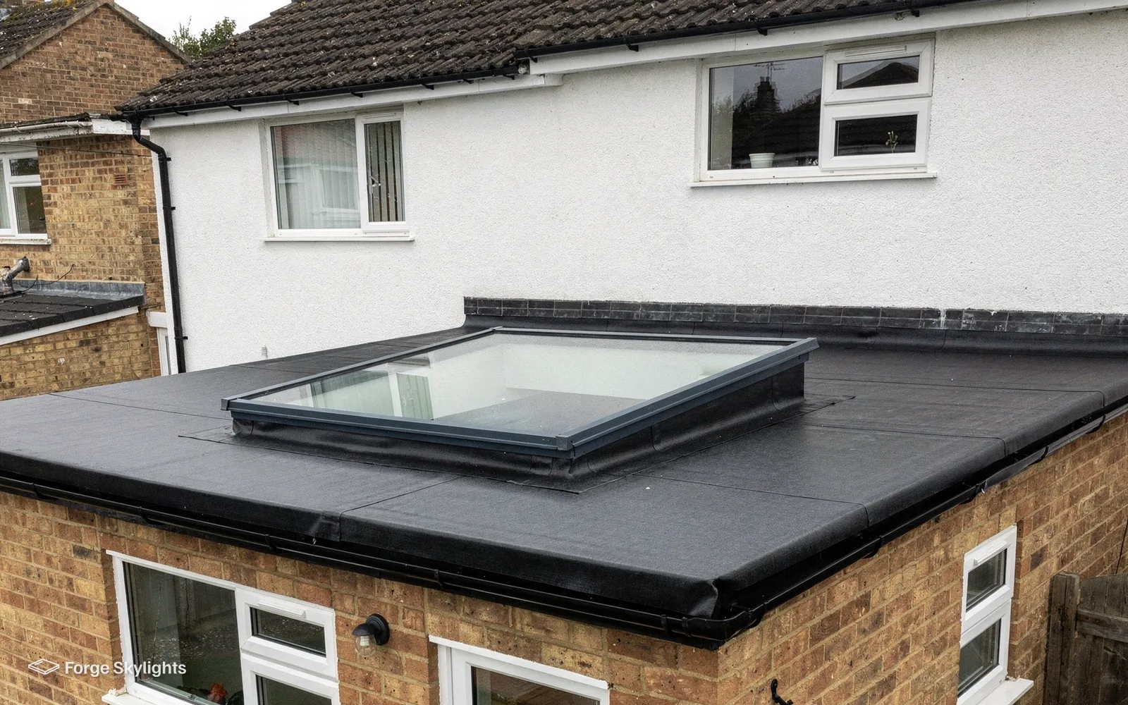 A flat rooflight on the roof of a brick extension