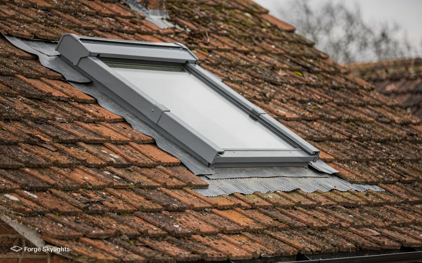 A roof window in a clay tile roof