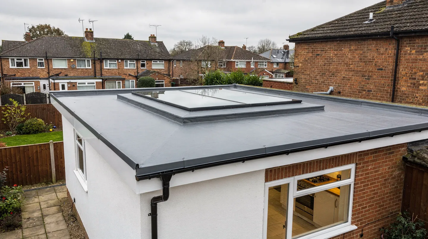 A flat glass rooflight on the roof of a single-storey rear extension