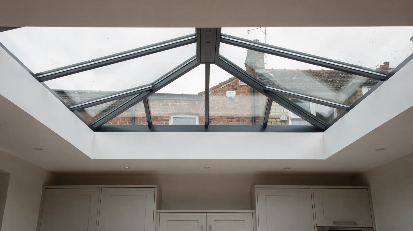 Looking up through a grey aluminium roof lantern in a kitchen extension ceiling